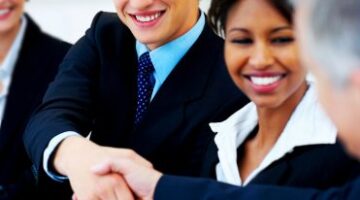 Two business men shaking hands at international business meeting.