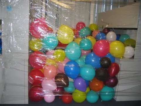 funny work pranks using balloons in an office cubicle